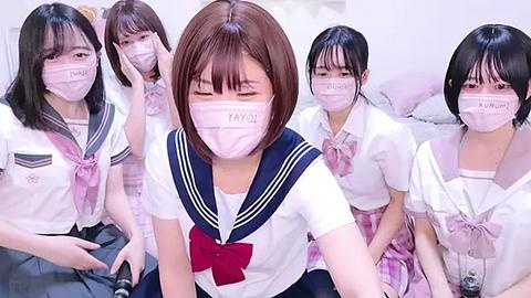 Media: Video of four Japanese schoolgirls in sailor uniforms, masks, and bows, sitting closely together, appearing distressed, possibly crying.