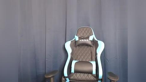 Media: A video of a black and turquoise gaming chair with a quilted pattern, labeled \"Krings,\" against a plain, dark gray background.