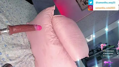 Media: Video of a pink dildo inserted into a woman's anus, seen from behind, with her large buttocks prominently displayed. Background shows a bedroom with a bed, pink lighting, and a social media notification.