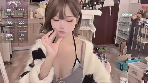 Media: Video of an Asian woman with light skin, wearing a revealing outfit with a black bra, posing seductively in a messy room, surrounded by clutter.