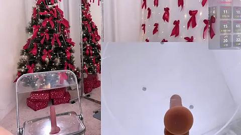 Media: A video of a modern bathroom with a clear chair and a white bathtub, featuring a festive Christmas tree and red bow shower curtain.