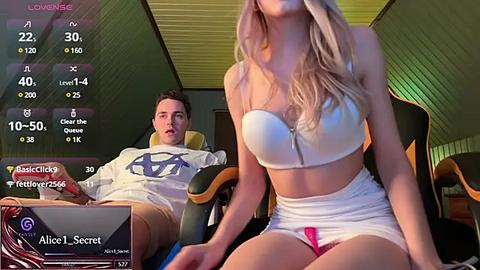Media: Video of a blonde woman in a white bikini and a man in a white shirt and shorts, in a dimly lit room with a virtual reality headset, labeled as \"Alice I Secret.\