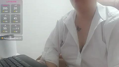 Media: A video of a light-skinned person with a small tattoo on their neck, wearing an unbuttoned white shirt, sitting at a desk. A smartphone displays a fitness app interface in the background.