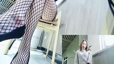 Media: Video of a woman in fishnet stockings, sitting on a chair, reflecting in a mirror, wearing a striped sweater.