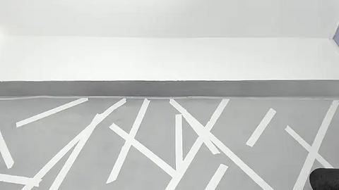 Media: A black-and-white video of a minimalist interior ceiling with white diagonal lines painted on a light gray surface. The lines create a geometric pattern against a plain white wall.