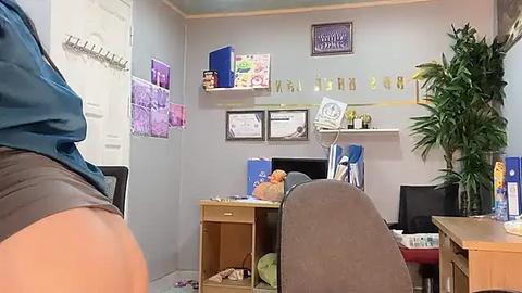 Media: A video of a cluttered office with a beige desk, awards, plants, and a \"Welcome to My Office\" sign.