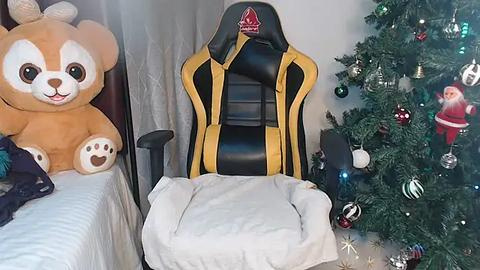 Media: Video of a plush Corgi toy, black and yellow gaming chair, and a decorated Christmas tree in a cozy, festive room.