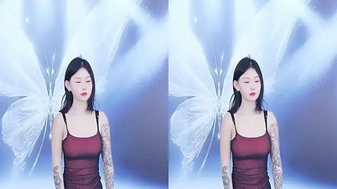 Media: Video of a fair-skinned Asian woman with long black hair, wearing a maroon camisole and intricate sleeve tattoos, standing in front of a blue and white butterfly backdrop.