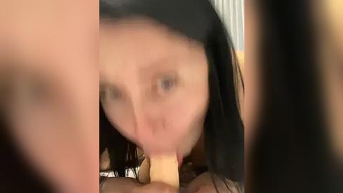 Media: A blurred video shows a woman with straight black hair and fair skin, performing oral sex on a man with light skin.