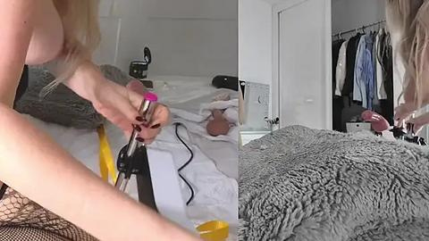 Media: Video of a blonde woman using a vibrator on herself in a messy bedroom with a bed and clothes hanging in the background.