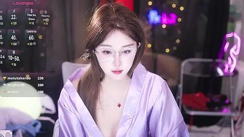 Media: Video of a young woman with fair skin, wearing glasses and a light purple robe, indoors with dim lighting, showcasing a live stream overlay.