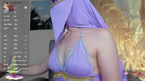 Media: Video of a woman with fair skin, wearing a purple hijab and revealing lingerie, sitting at a desk. Background shows a virtual chat window with online stats.