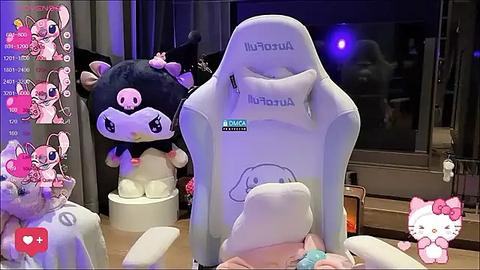 Media: A video of a plush Minions character and a white gaming chair with a Hello Kitty sticker, in a dimly lit room with purple lighting and a window.