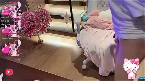 Media: Video of a pink Hello Kitty-themed bedroom with a bed, pink flowers, and a person in a white shirt, with a virtual chat interface overlay.