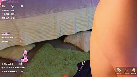 Media: Video of a close-up of a naked person's buttocks, with a green rug and a beige bedspread visible in the background. The image also features a digital watermark and a social media username.