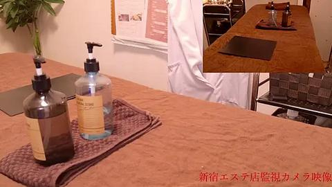 Media: Video of a kitchen countertop with two water bottles, a hand sanitizer, and a dish towel. In the background, a chef in a white apron works near a stove.