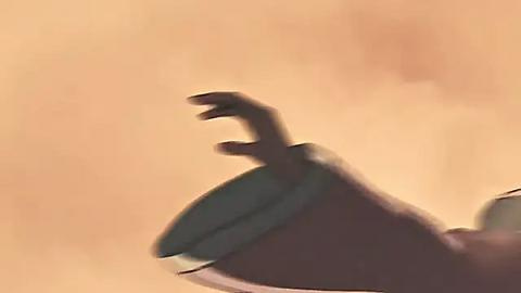 Media: A video showing a blurry hand with claws extending, possibly from a creature or character, against a warm, beige background. The image lacks detail and is heavily blurred, emphasizing movement and a mysterious, otherworldly atmosphere.