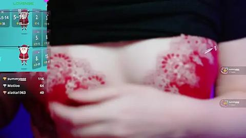 Media: A video of a fair-skinned woman with large breasts, partially exposed in a red lace bra, captured from a close-up angle.