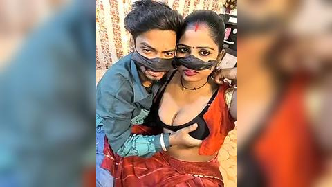 Media: Video of two Indian women in traditional attire, with one covering the other's breast, wearing face masks, against a floral wallpaper background.