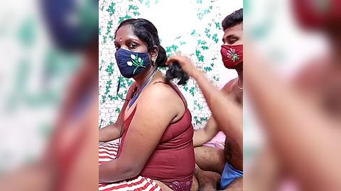 Media: Video of two Indian women in traditional sarees, wearing masks, with one combing the other's hair. Background features floral wallpaper.