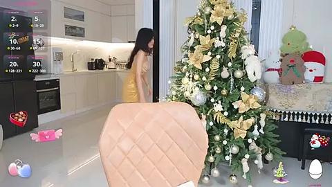 Media: Video of a modern kitchen with a decorated Christmas tree, a woman in a yellow dress, and a plush toy bear, featuring a virtual reality overlay.