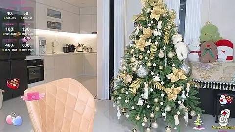 Media: A video featuring a modern kitchen with a white chair and a festive decorated Christmas tree adorned with gold ornaments and white lights.