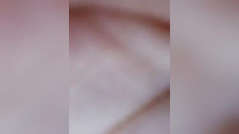 Media: A blurred video featuring three vertical white lines, suggesting a minimalist abstract art style. The background is indistinct, creating a soft, dreamy effect. The overall image is smooth and monochromatic, lacking discernible details or recognizable objects.