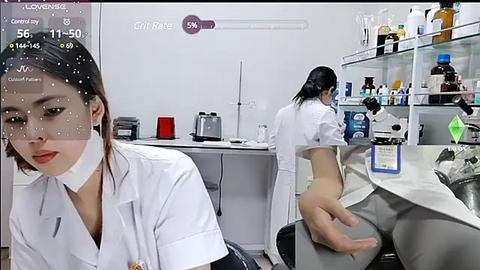 Media: A video of a laboratory with two women, one dressed in a white lab coat and another in a lab coat and panties, working at a desk.