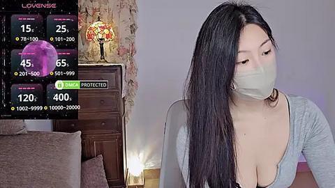 Media: Video of an Asian woman with long black hair, wearing a mask, grey top, and seated indoors, with a live stream overlay showing 150 viewers.