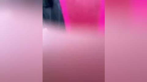 Media: A blurred video featuring a pink and purple gradient background, possibly with a person partially visible, suggesting a misty or smoky effect.