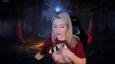 Media: Video of a blonde woman in a dark forest, wearing a red shirt, lifting her shirt to reveal her breasts. A black gaming chair and a glowing moon in the background.