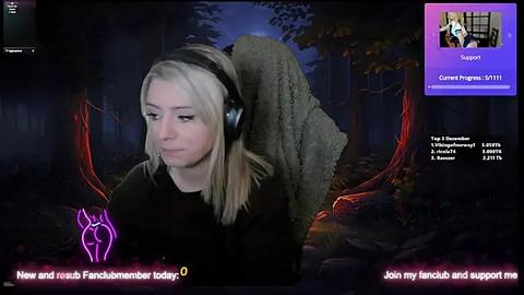 Media: Video of a blonde woman wearing headphones, looking upset, in a dark forest with glowing red tree roots, overlayed with Twitch chat messages.