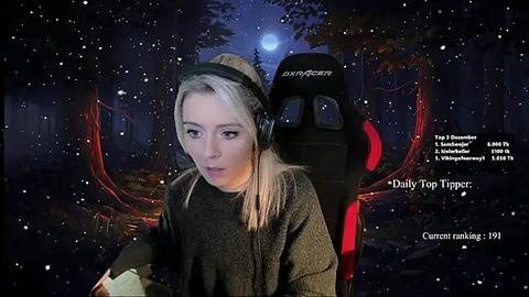 Media: Video of a young woman with blonde hair, wearing headphones, in a dark room with a moonlit forest background. Text overlays mention \"Daily Top Tipper\" and \"current nitrado.net server.\