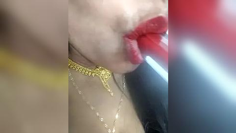 Media: A close-up video of a woman's face, partially obscured by a foggy filter, showing bright red lipstick, gold necklace, and blurred background.