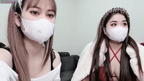 Media: Video of an Asian woman in a white face mask and black lace bra, wearing a leopard print headband and fur-trimmed red dress.