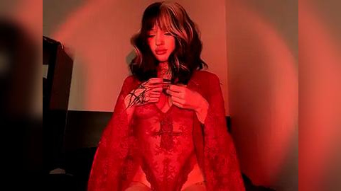 Media: A video featuring a woman with long, wavy hair, wearing a red lace bodysuit, holding a knife against her neck in a dimly lit room with red lighting, creating a menacing and intense atmosphere.