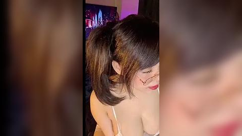 Media: Video of a young Asian woman with shoulder-length black hair in pigtails, wearing a white lace bralette, captured from a low angle.