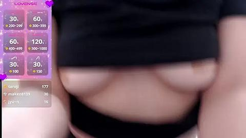 Media: A blurred close-up of a person's partially lifted black top, revealing a hint of their light-skinned breast, set against a purple background with a \"LOVENSE\" overlay.
