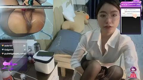 Media: A video of a young Asian woman in glasses, wearing a white blouse, sitting in a dimly lit room with a plush teddy bear, a laptop, and a glass of water.