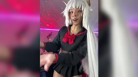 Media: Video of a cosplay event featuring a dark-skinned woman with long, white hair, wearing a black and red schoolgirl outfit, posing dramatically with outstretched arms. Background has blurred pink and purple lights.