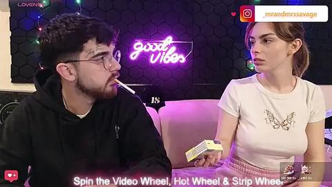 Media: Video of a man and woman on a talk show; man smokes, woman holds a Hot Wheels car.