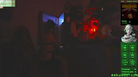 Media: A dimly-lit, grainy video shows a person wearing a black hooded sweatshirt and headphones, standing in a cluttered room with a red-lit pumpkin. The image has a \"skukubra.com\" watermark.