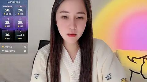 Media: Video of an East Asian woman with long black hair, wearing a white robe, against a colorful abstract background. Weather app displays on the left.