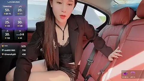 Media: A video of a young Asian woman in a black leather jacket, sitting in a red leather car seat, wearing a black lace bra and short shorts, with a smartphone screen showing weather data.