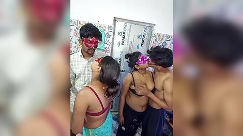 Media: Video of a group of South Asian women in a bathroom, wearing pink masks, revealing their bare breasts, with a man in a plaid shirt observing.