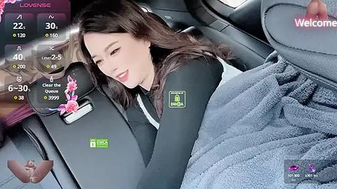 Media: Video of a young woman with long brown hair, wearing a black hoodie, sleeping in a car seat, surrounded by a virtual reality headset display showing health metrics.