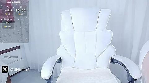 Media: Video of a modern, white leather office chair with a sleek, ergonomic design in a minimalist room with white walls and curtains.