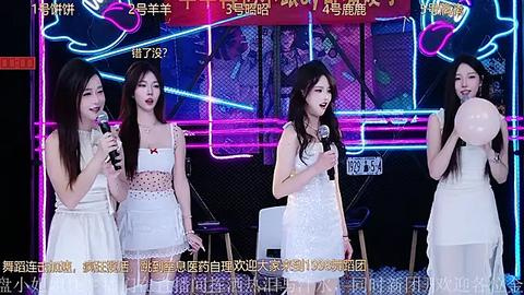 Media: Video of four Asian women, dressed in white dresses, singing into microphones on a stage with vibrant neon lights and a Chinese text overlay.