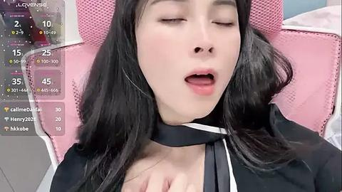 Media: Video of an Asian woman with long black hair, wearing a pink headband and black choker, lying on a pink chair, mouth slightly open, eyes closed, with a \"calm\" status overlay.