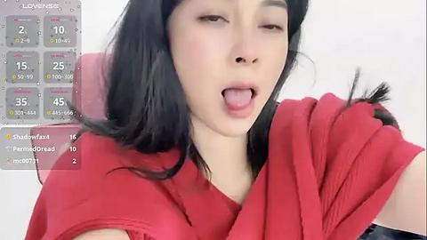 Media: Video of a young East Asian woman with long black hair, wearing a red top, and licking her lips, against a white background.